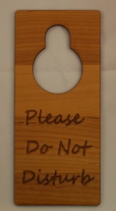 a wooden sign with a circle cut out