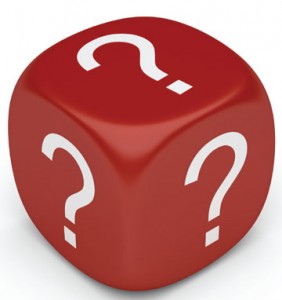 a red dice with white question marks