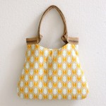 a yellow and white bag on a white wall