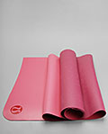a pink yoga mat on a white background