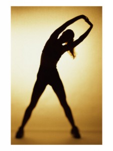 a silhouette of a woman stretching