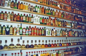a shelf with bottles of alcohol
