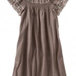 a brown dress with white embroidery