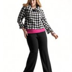 a woman in a checkered shirt and black pants