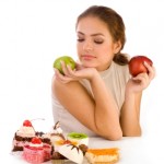 a woman holding apples and a few desserts