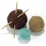 a group of yarn balls with wooden needles