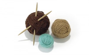 a group of balls of yarn with wooden needles