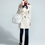 a woman in a white coat holding a white bag and a white purse