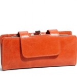 an orange purse with a clip