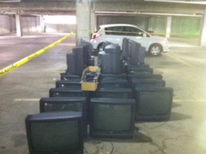 a group of televisions in a parking lot