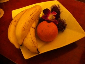 a plate of fruit and a flower