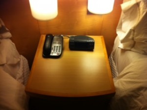 a telephone and alarm clock on a table