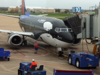 a plane being loaded onto a gate