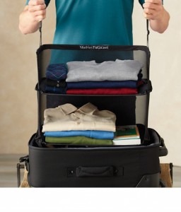 a person holding a suitcase full of clothes