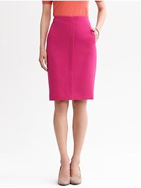 a woman wearing a pink skirt