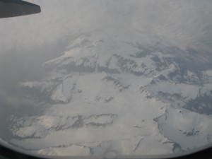 a view of a snowy mountain from an airplane window