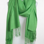 a green scarf on a mannequin