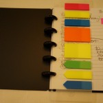 a notebook with colorful sticky notes