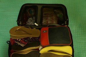 a suitcase with shoes and bags