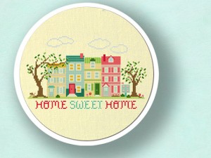 a cross stitch of a row of houses