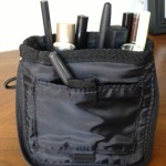 a black bag with makeup brushes and lipsticks