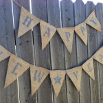a group of burlap flags on a fence