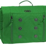 a green messenger bag with buttons