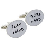 a pair of cuff links with words on them