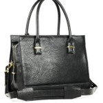 a black leather handbag with gold accents