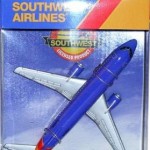 a blue and silver airplane in a plastic package