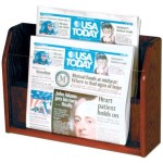 a wooden magazine holder with newspapers