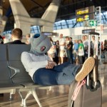 a person in a mask sleeping on a bench