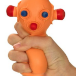 a hand holding an orange toy