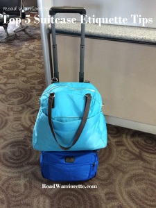 a blue bag on top of a suitcase