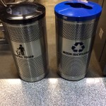 two metal trash cans with a blue lid