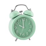 a green alarm clock with bells