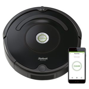 a robot vacuum cleaner next to a phone