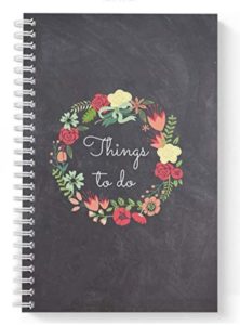 a notebook with a floral wreath